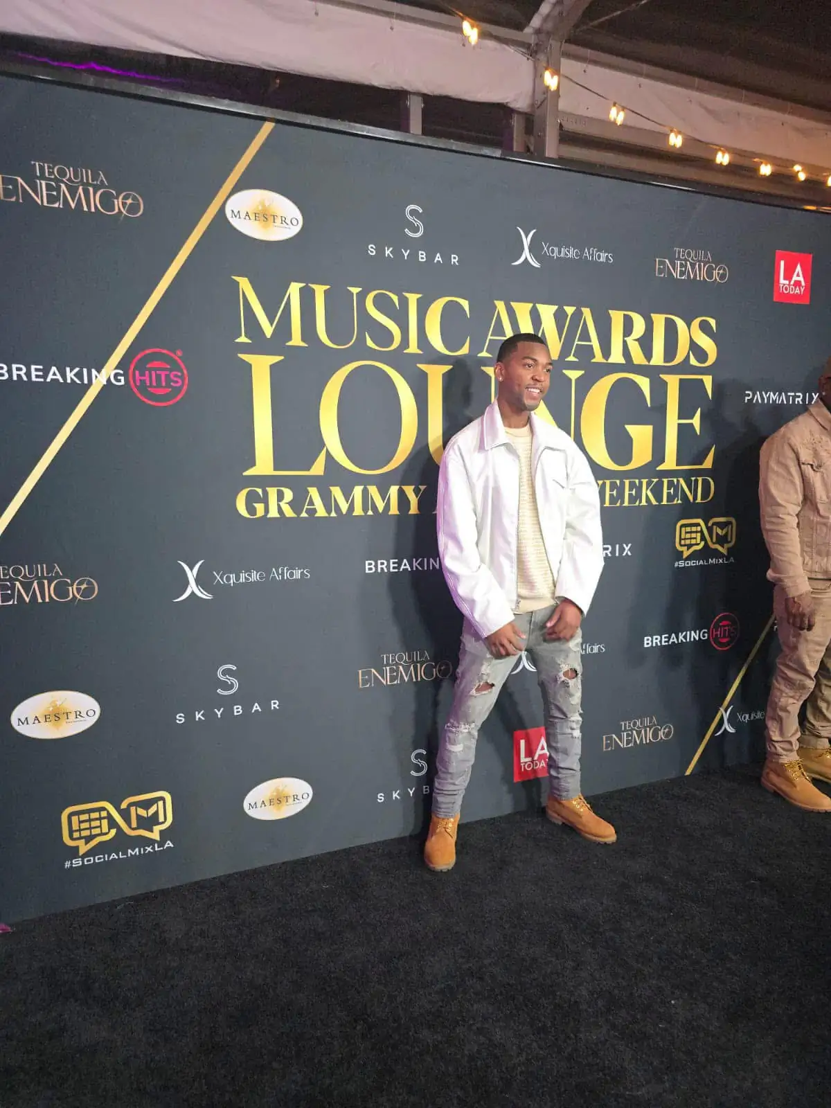 Bren Got Hits in a white jacket on the red carpet at the Music Awards Lounge during Grammy Awards weekend