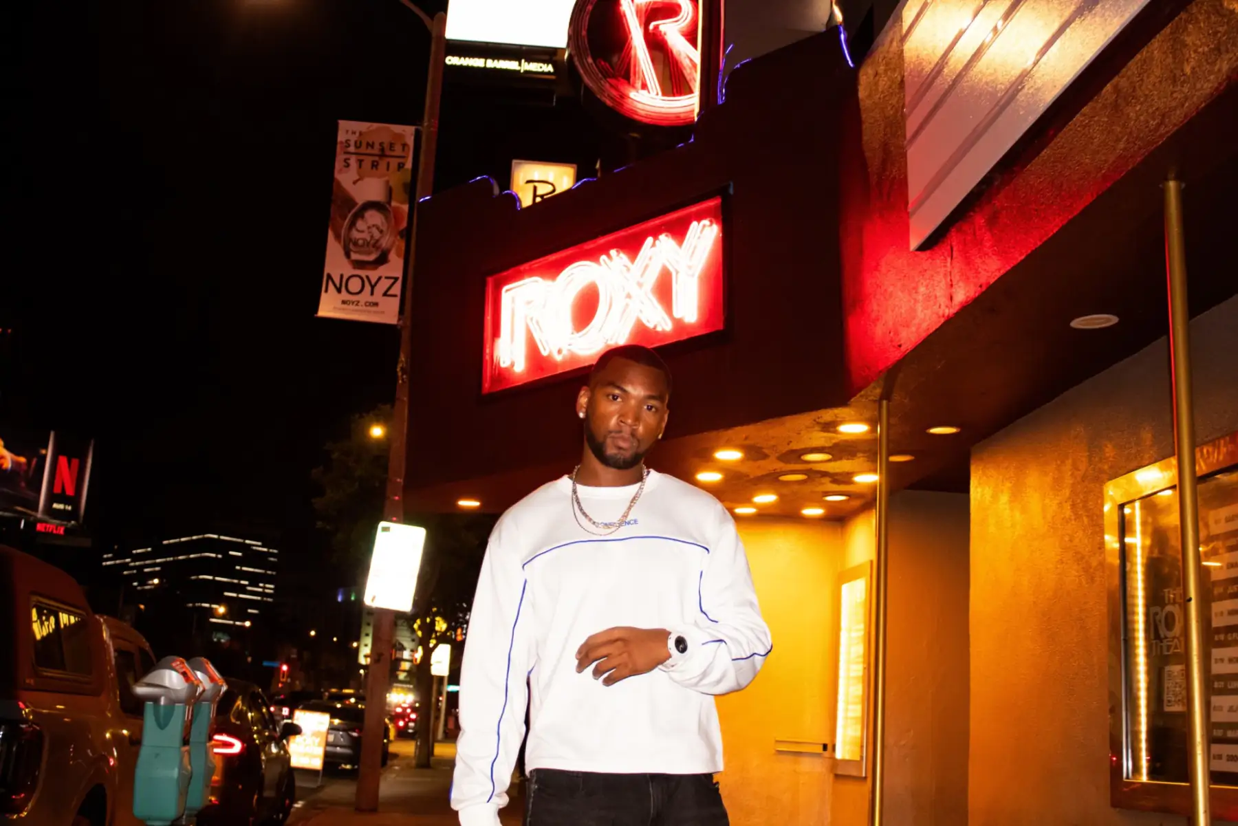 Bren Got Hits under the red neon Roxy sign on the Sunset Strip